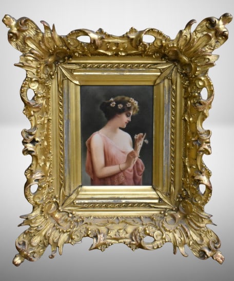 Framed KPM porcelain plaque of woman holding daisies, artist signed: Framed KPM porcelain plaque of woman holding daisies, artist signed; Plaque measures: 7" x 5", overall frame size is 16" x 13.5" - Artist signed "Wagner", backside is inscribed "Marguerite van Riesen"