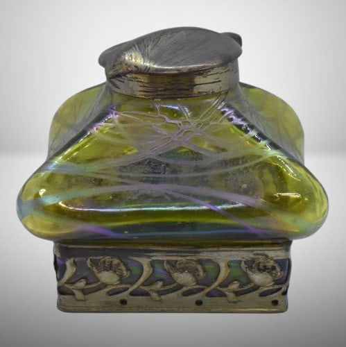 Art Nouveau inkwell w/ green iridescent glass and brass hinged cover, 4" sq. dia. x 4" tall: Art Nouveau inkwell w/ green iridescent glass and brass hinged cover, 4" sq. dia. x 4" tall; floral embossed metal overlay base, poss. Loetz