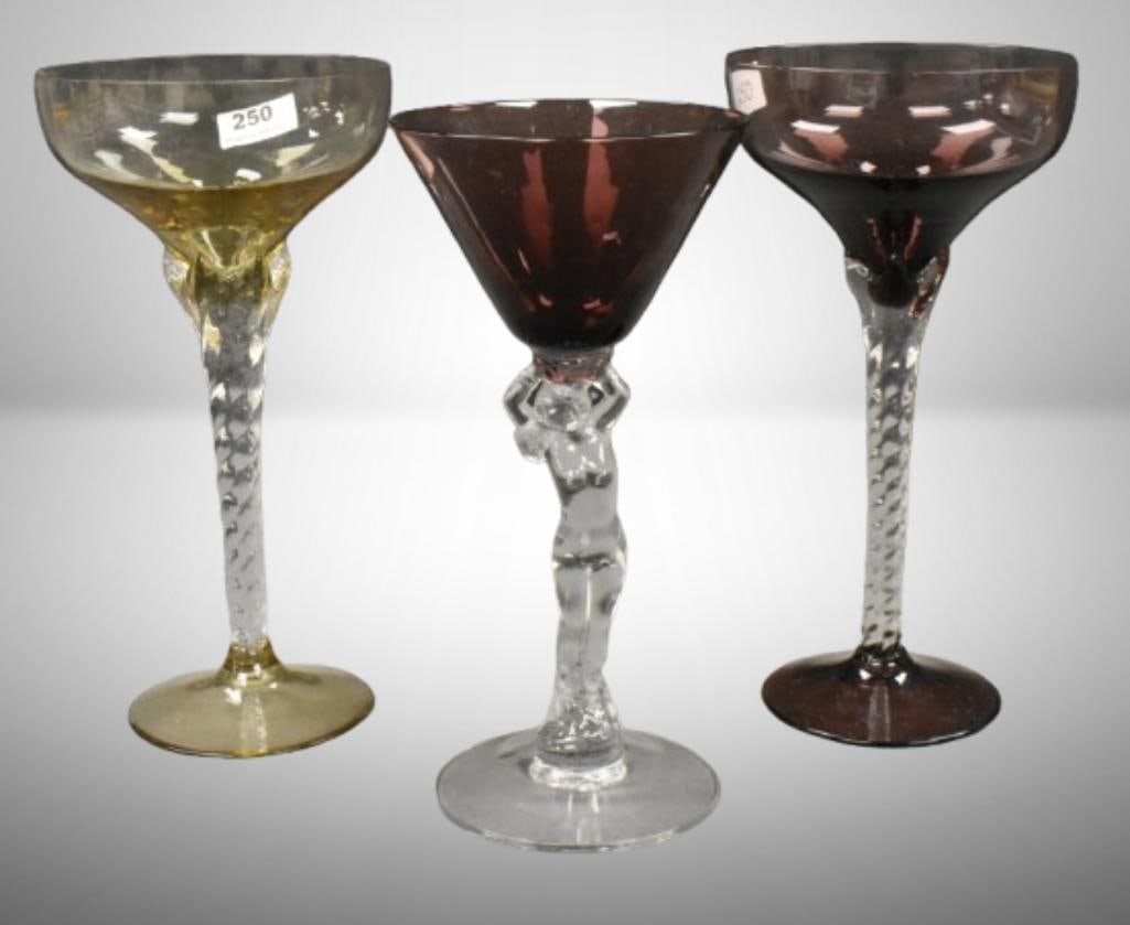 (3) Elegant martini cocktail 6.5" glasses; 2 w/ twisted stems; 1-w/ figural nude (possibly: (3) Elegant martini cocktail 6.5" glasses; 2 w/ twisted stems; 1-w/ figural nude (possibly Cambridge). Please use pictures as part of the description. Brown Auction attempts to call any flaw that can