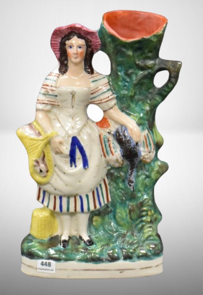 Staffordshire 11.5" figural spill vase - Girl w/ rabbit in basket ; . Please use pictures as part of: Staffordshire 11.5" figural spill vase - Girl w/ rabbit in basket ; . Please use pictures as part of the description. Brown Auction attempts to call any flaw that can affect the value of each piece. I