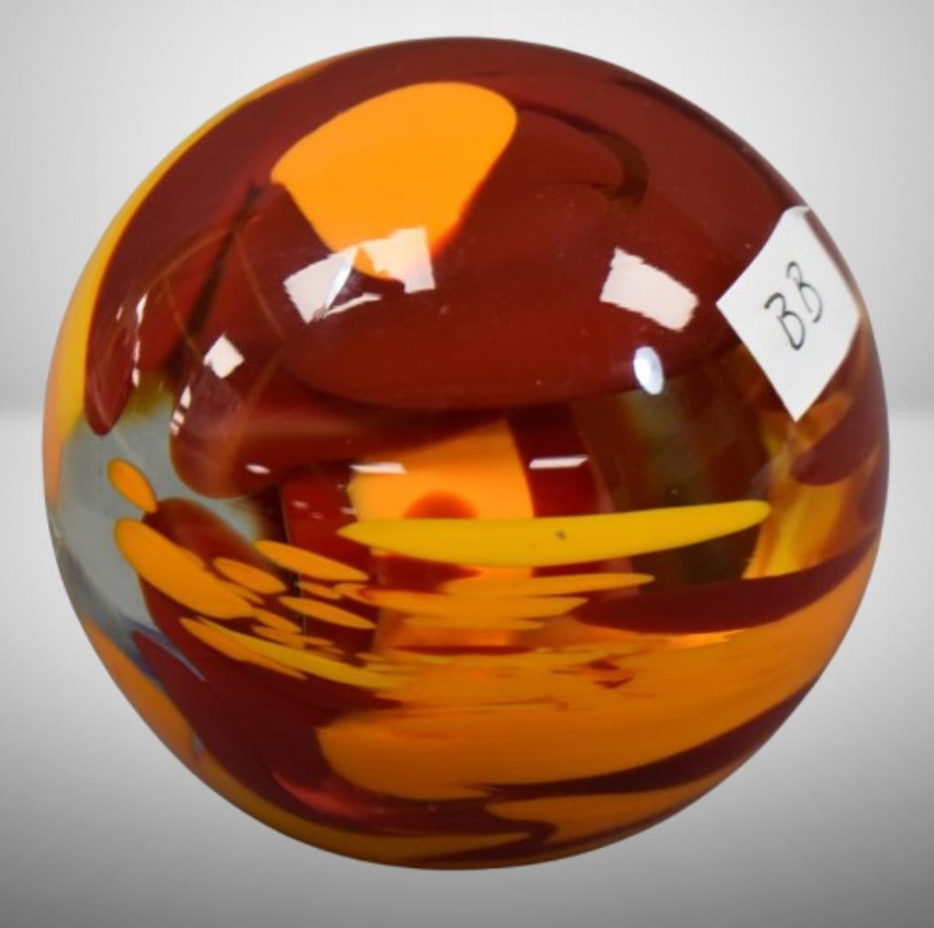 Art Glass paperweight, clear w/ green free form, artist signed but can't make out: Art Glass paperweight, clear w/ green free form, artist signed but can't make out; 3" tall. Please use pictures as part of the description. Brown Auction attempts to call any flaw that can affect the