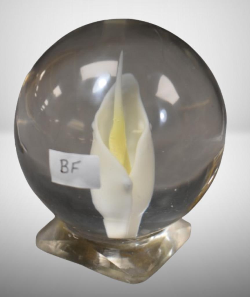Art Glass paperweight, clear w/ lily: Art Glass paperweight, clear w/ lily; 3.75" tall. Please use pictures as part of the description. Brown Auction attempts to call any flaw that can affect the value of each piece. It is the buyer's res