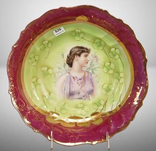 Royal Saxe Germany Decorative 9.5"d Bowl: Hand-painted porcelain decorative bowl by Royal Saxe, Germany. Features a multicolor design with floral motifs and a central figure. Edged in gold with a chip on the bottom rim. Maker's mark present o