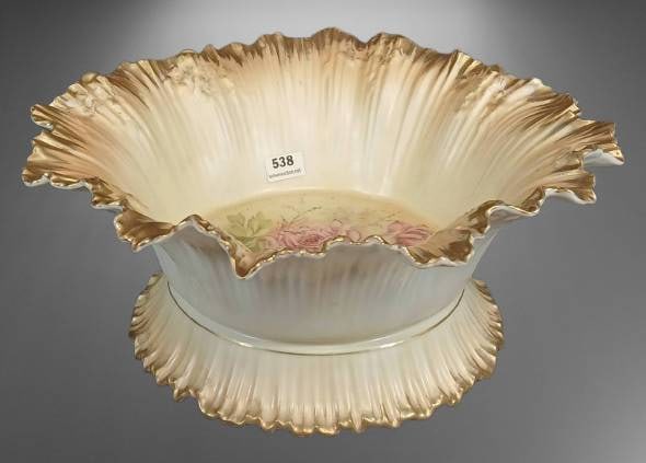 RS Prussia Bowl With Floral Design and Gilded Edges: RS Prussia porcelain bowl featuring hand-painted pink roses with delicate detailing, adorned with gilded ruffled edges. RS Prussia red mark. 4" tall x 10"d. The piece is in good condition with some mi