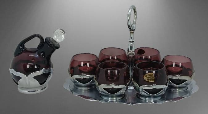 Farber Bros New York Amethyst Glass Liquer Set: Farber Bros New York amethyst glass set featuring six Cambridge glasses, an oval-shaped metal tray with handle, and a matching pitcher with glass stopper. The metal components are chrome plated, and t