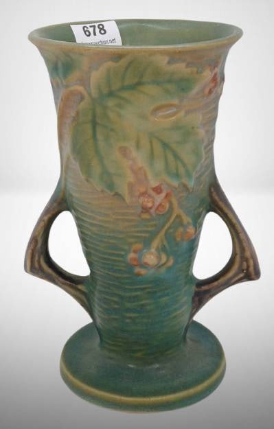 Roseville Bushberry 30-6" Vase, Green: Roseville Pottery Bushberry vase, model 30-6", in green. Features double handles and raised motifs of berries and leaves. Marked on bottom. No chips, cracks, or repairs. Approximately 6 inches tall.