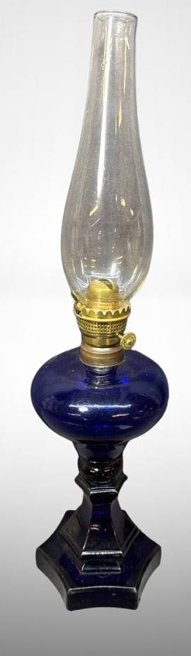Cobalt Blue Glass Oil Lamp With Brass Burner: Cobalt blue glass oil lamp featuring a hexagonal base, brass burner marked 'E.F. Jones Boston Patent Jan 11 1859,' and a clear glass chimney. Measures approximately 13 inches tall with the chimney. Ap