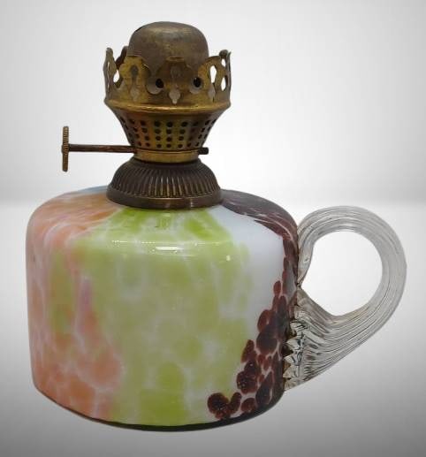 Multicolored Glass Oil Lamp with Brass Burner: Multicolored glass oil lamp featuring a vibrant swirled design in orange, blue, green, and red. Includes a ribbed clear glass handle and a brass burner marked 'English Made.' The piece shows signs of 