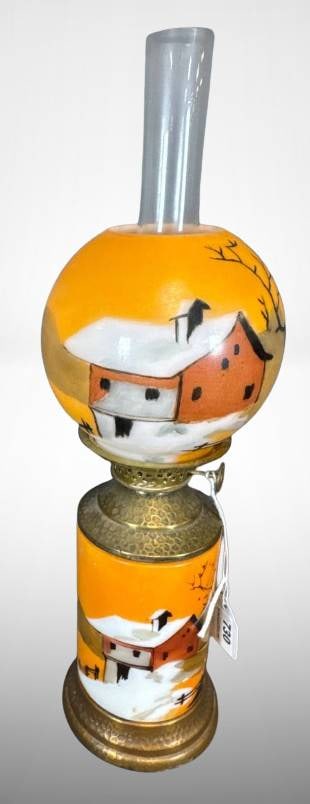Hand-Painted Scenic Miniature Oil Lamp ?: Hand-painted oil lamp featuring a brass base and an orange glass font and globe. The decoration includes winter scenes with snow-covered buildings and trees. Includes a removable chimney and burner. T