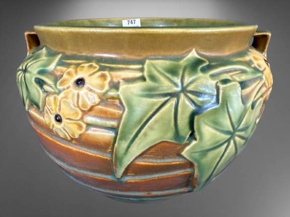 Roseville Luffa 631-7" Brown Jardiniere: Roseville Luffa pattern jardiniere, with a brown exterior featuring raised floral and leaf designs. The piece measures 7 inches and includes two small handles. Marked on the base with the Roseville US