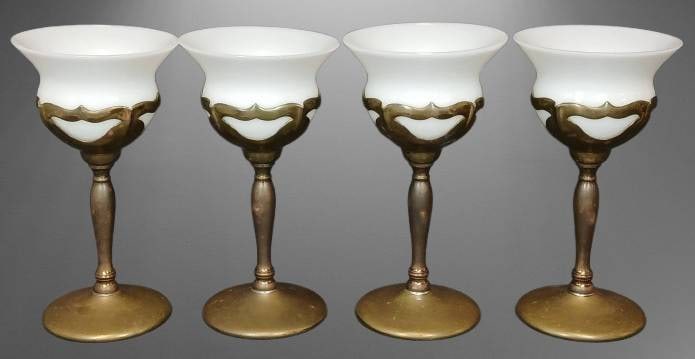 4 Faber Bros. Solid Brass Goblets: Four white glass goblets with solid brass bases and stems by Faber Bros. Each goblet features a decorative brass design around the glass. The bases are marked "Faber Bros." and have care instructions