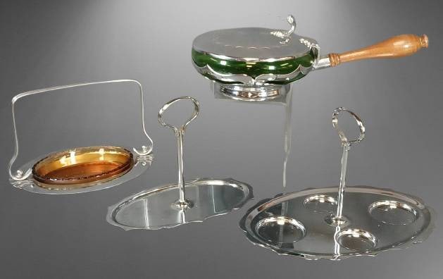 Farber Bros. Chrome and Glass Serveware Set: A Farber Bros. chrome dish with green glass liner and wooden handle, marked on the base, a second oval tray with amber glass liner and chrome handle, and 2-chrome trays, suitable for serving. ?