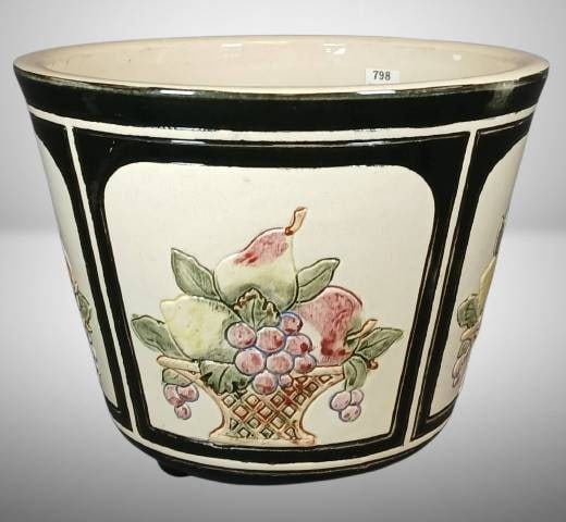 Weller Rosemont Jardiniere with Fruit Design: Weller Rosemont 8" tall jardiniere featuring hand-painted fruit basket designs on a cream and black background. Made of ceramic, with a marked base. Includes four feet at the bottom. Appears in good c