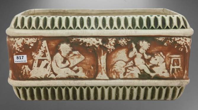 Roseville Donatello Rectangular Planter: Rectangular planter from the Roseville Donatello line. Features decorative relief scenes on its sides and a ribbed border detail. Displays age-related wear, including a visible crack on one corner. Di
