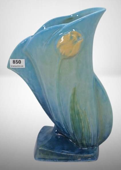 Roseville Wincraft 282-8" Blue Tulip Vase: Roseville Wincraft 282-8" vase in a blue tulip design, made of ceramic. Features a unique flowing form with embossed yellow tulip decoration. Marked on the underside with the Roseville USA 282-8" stam