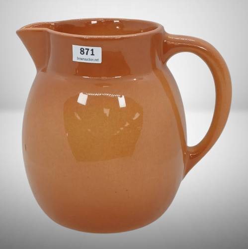 Roseville Raymor Modern Stoneware Pitcher: Roseville Raymor #16 pitcher in vibrant rust glaze with an ergonomic handle and spout. Marked "R 16 USA" on the base. Displays visible crazing consistent with age. Ideal for collectors of Roseville po