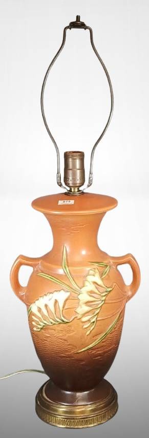 Roseville Freesia 127-12" Factory Lamp, tangerine: Roseville Freesia 127-12" vase factory lamp in tangerine finish with floral relief design. Features large vertical crack on one side and additional crack at the base. Includes original metallic base a