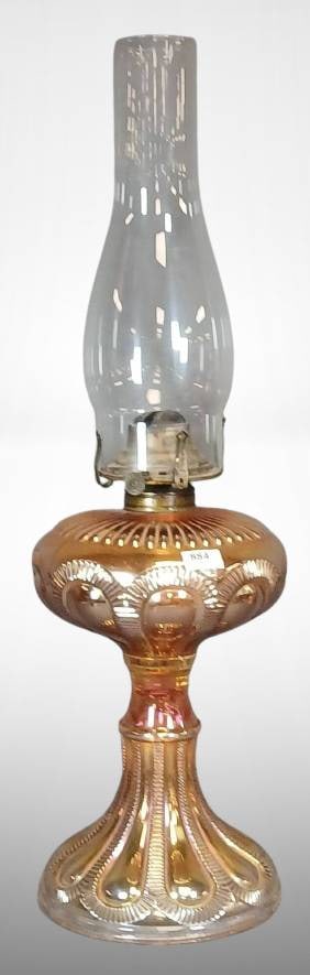 Carnival Glass Zipper Loop Kerosene Stand Lamp: Carnival glass kerosene lamp by Imperial Glass featuring the Zipper Loop design. Includes brass Queen Anne No. 2 burner and detachable glass chimney. Made of marigold iridescent glass with vibrant hue