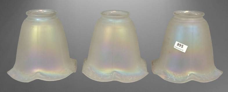 Three Iridescent Frosted Glass Lamp Shades: (3) Matching iridescent frosted glass lamp shades featuring a ruffled design and floral etchings around the bottom edge. Suitable for use on antique or vintage lighting fixtures. Lovely pearlescent fi