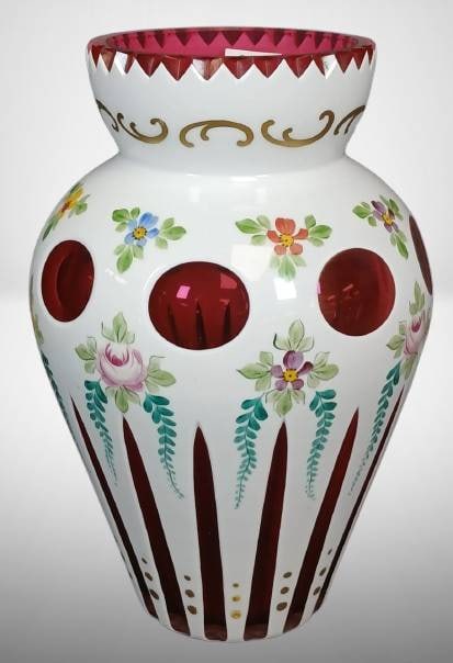 Czech Bohemian Overlay Cut-to-Cranberry Vase: Handcrafted Czech Bohemian overlay vase with white and cranberry glass. Features hand-painted floral designs, gold accents, and cut-to-cranberry decorations. The vase measures approximately 8.5 inches