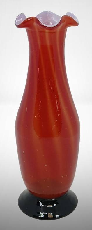 Czech Red Glass Vase with Ruffled Edge: Czech glass vase crafted in translucent red glass with a ruffled edge top and contrasting black base. Detailed craftsmanship is evident in the smooth finish and elegant design. Dimensions indicated by