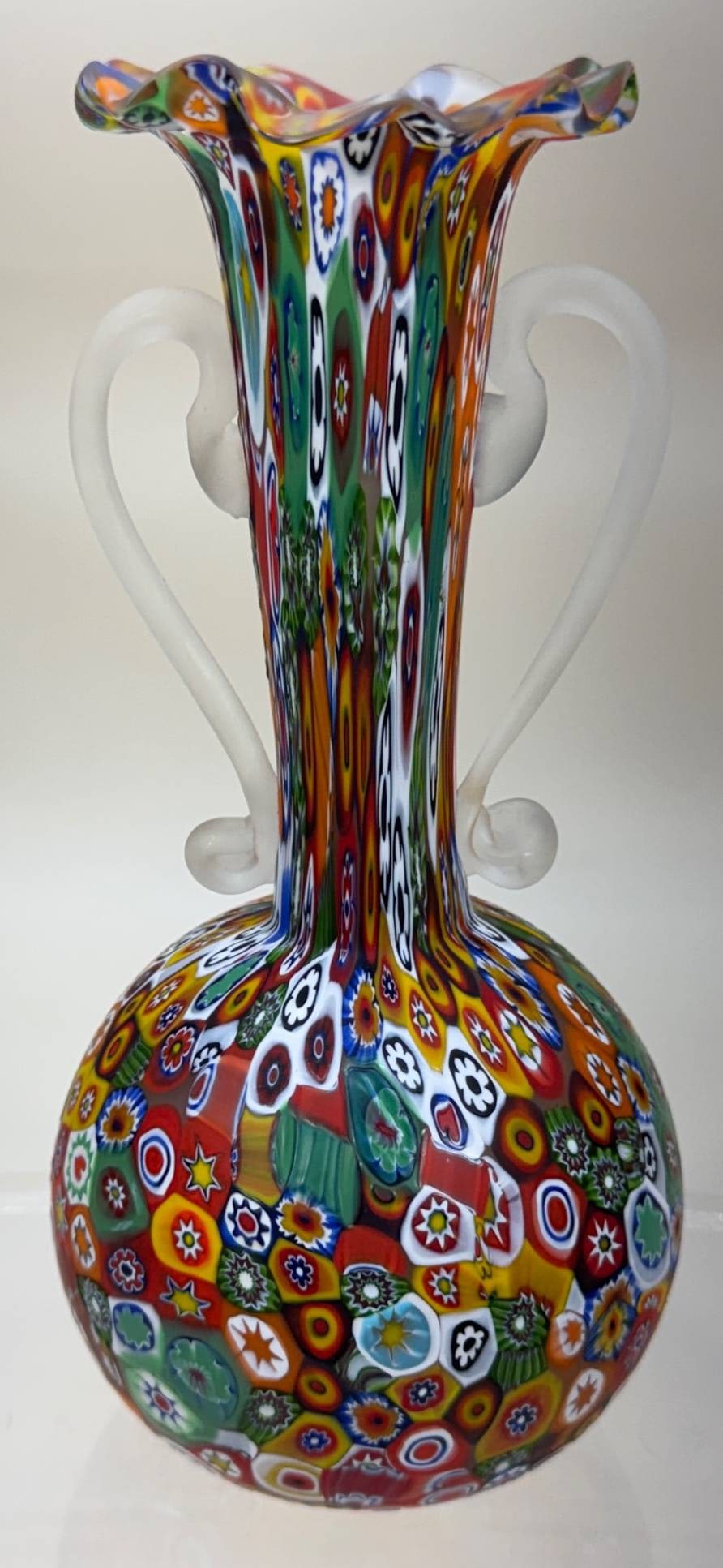 Murano Millefiori Vase with Handles, 7.5" Tall: Murano Millefiori vase standing 7.5" tall, featuring vibrant Millefiori designs and two frosted glass handles. Free of chips, cracks, or repairs. In-house shipping available.