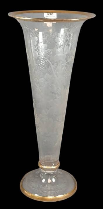 Hand-Blown Clear Glass Trumpet Vase: Hand-blown clear glass trumpet vase featuring an intaglio engraving of a vine and grape pattern with gold-gilded rim and base (possible Moser). Measures 13" tall.? No chips, cracks or repairs. In-hous