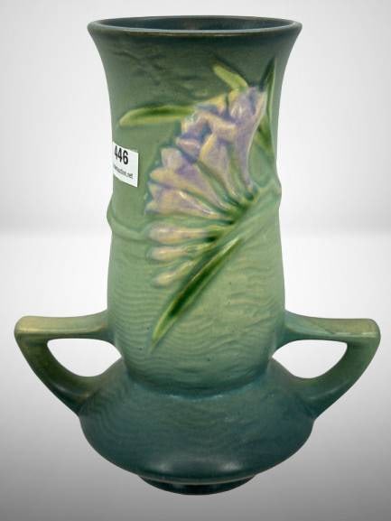 Roseville Freesia 119-7" Vase in Green: Roseville Freesia 119-7" vase, featuring a green glaze with raised floral decoration and double handles. A classic example of Roseville Pottery craftsmanship. No chips, cracks or repairs.? In-house sh