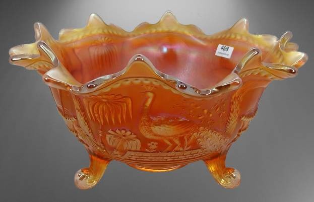 Northwood Carnival Glass Peacock at Fountain Bowl, Marigold?: Northwood Carnival Glass Peacock at the Fountain bowl in marigold, featuring scalloped edges, intricate embossed designs, and three scrolled feet. The bowl exhibits rich iridescent hues and displays t