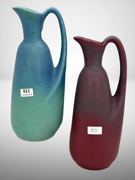 Van Briggle Pottery Ewers in Blue and Red: (2) Van Briggle pottery 9" ewers in gradient blue-green and mulberry matte finishes. Bottoms marked with Van Briggle Colorado Springs. No chips, cracks or repairs. In-house shipping available.