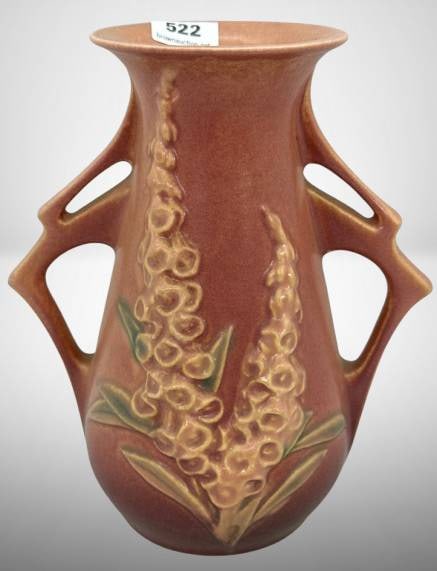 Roseville Foxglove 44-6" Vase, pink: Roseville Pottery Foxglove 44-6" vase in a pinkish-brown glaze, featuring raised floral decoration and double cut-out handles. Marked on the base. No chips. cracks or repairs. In-house shipping availa