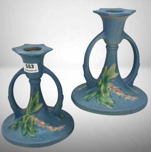 Roseville Bleeding Heart 1139-4" Candlesticks, blue: Roseville Bleeding Heart candlesticks, model 1139-4", in blue finish. Condition notes: one stick exhibits a surface imperfection, possibly a chip repair. In-house shipping available.