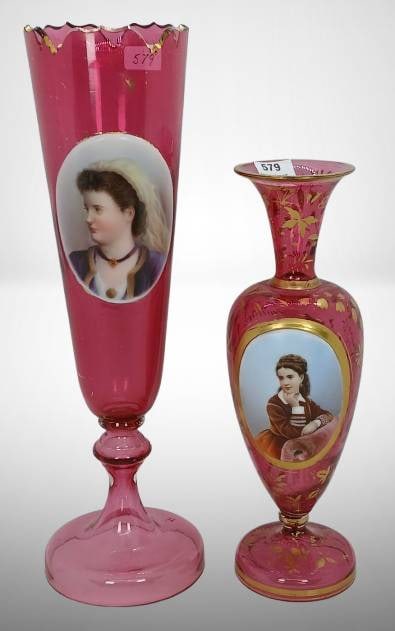 (2) Cranberry Bohemian Portrait Vases: (2) Cranberry Bohemian portrait vases, both featuring hand-painted female figures. One measures 12.5" tall with gold scalloped edge; one measures 9.5" tall with nice gold detailing. Both vases are fre