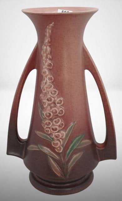 Roseville Foxglove 51-10" Vase, Pink: Roseville Foxglove 51-10" vase with a pink glaze, featuring a raised floral design. Dual side handles. Condition appears to be very good with no visible chips or cracks. In-house shipping available.