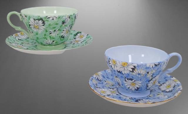 (2) Shelley England Fine Bone China Tea Cups and Saucer Sets: (2) Shelley Fine Bone China tea cup and saucer pairs in "Green Daisy" and "Blue Daisy" patterns, made in England, with pattern numbers 13450 and 13451. Both are in excellent condition, with no chips,
