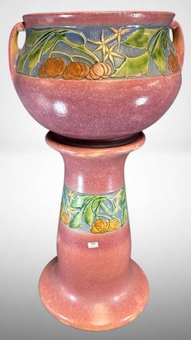 Roseville Baneda 626-10" Jardiniere and Pedestal, pink: Roseville Baneda 626-10" jardiniere and pedestal in pink. Features raised floral and pumpkin-themed details. Note a large tight hairline crack along the base of the pedestal. In-house shipping availab