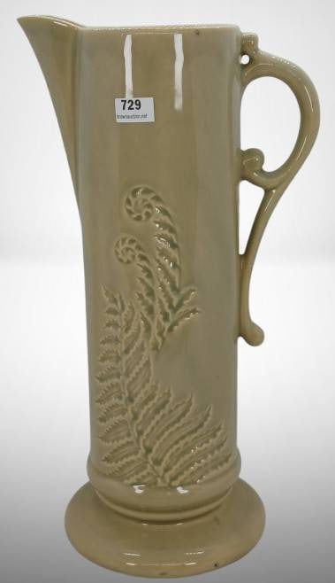Roseville Mayfair 1107-12" Tankard: This Roseville Mayfair 1107-12" tankard features a gray/beige finish with fern relief accents. Exhibiting a few overspray imperfections, it retains its charm and highlights Roseville's craftsmanship.