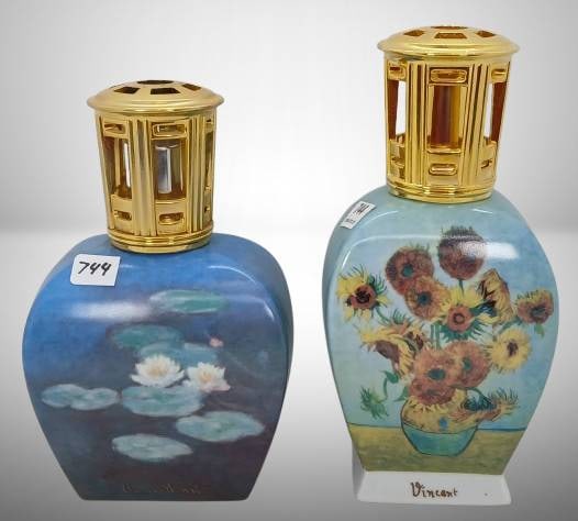 (2) Goebel Lampe Berger Paris Fragrance Lamps?: (2) Goebel Lampe Berger Paris fragrance lamps featuring designs inspired by Monet's water lilies and Van Gogh's sunflowers. Both pieces are porcelain with golden tops and bases. No chips, cracks, or r