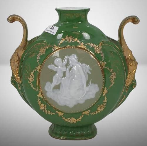 West German Fat Lava Green Vase: West German 'Fat Lava' vase featuring a green body with gold embellishments, ornate handles, and a pate-sur-pate style design depicting cherubs. No chips, cracks, or repairs. Measures approximately as