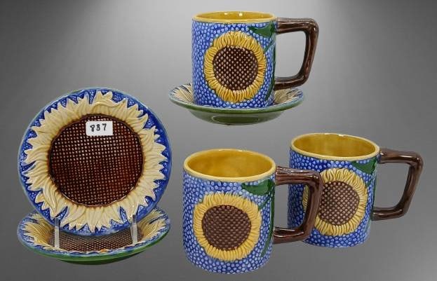 1991 MMA Majolica Set: This 1991 Metropolitan Museum of Art (MMA) Majolica-style Sunflower collection includes (3) 3.5"h mugs and (3) matching saucers. The mugs feature vibrant sunflower motifs with the unmistakable MMA mar