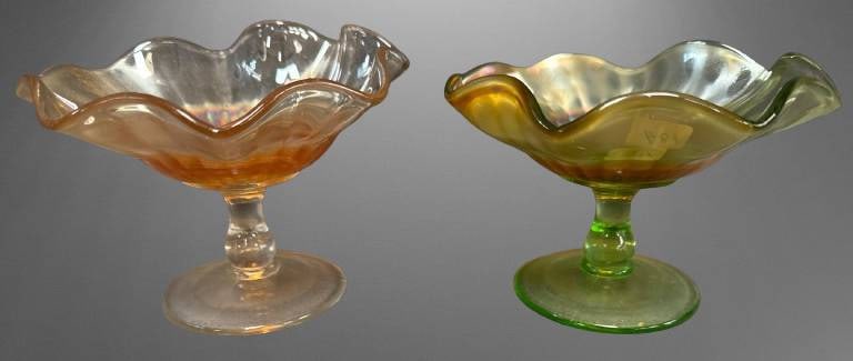 Carnival Glass Smooth Rays Compotes: This lot features (2) Carnival Glass Smooth Rays 4"h compotes, green and marigold. Both are in excellent condition with no chips, cracks, or repairs. The compotes showcase their distinctive ruffled ed