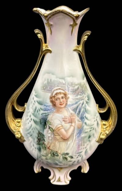 RS Prussia Winter Season Portrait Vase: This RS Prussia 11" portrait vase showcases a depiction of the Winter season, adorned with gold accents and intricate detailing. The rim has been repaired, as shown in the photos. This classic piece f