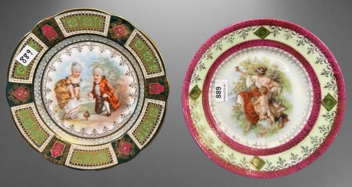 (2) Hand-Painted Decorative Porcelain Plates: This lot features (2) handpainted 6"d porcelain plates, each showcasing intricate designs. One bears a painted mark from Vienna, while the other is stamped Silesia, highlighting their European origins