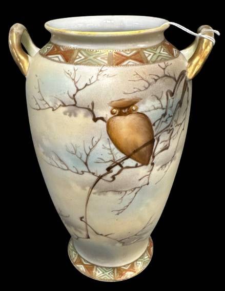 Handpainted Nippon Vase with Owl Design: This handpainted Nippon 8" vase features a delicate owl perched on a branch, surrounded by a serene natural landscape motif. Accented with geometric patterns and dual handles, it reflects exquisite cr