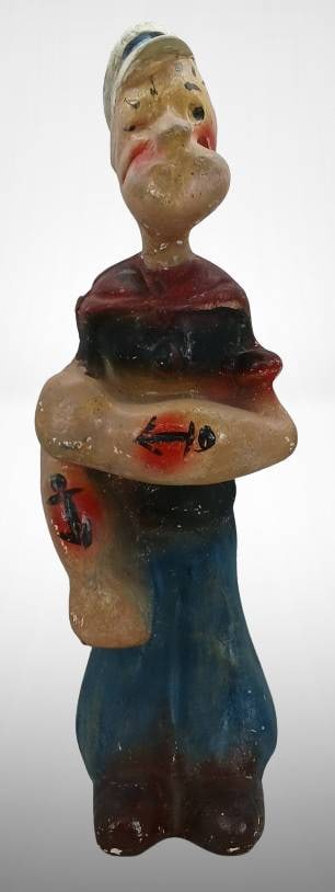 Popeye Chalk Figurine with Neck Damage: This chalk figurine depicts Popeye, complete with vibrant hand-painted details. It shows noted damage to the neck area, as indicated in the photographs. This is a charming collectible for enthusiasts 