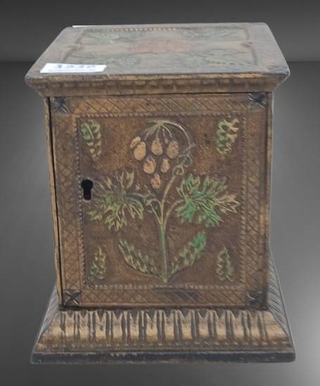 Antique Cast Iron Floral Still Bank: This antique cast iron still bank features floral designs on all sides and includes a keyhole for secure storage. The craftsmanship reflects its historical significance, with aged patina and hand-pain