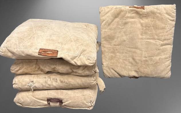 Wilson Canvas Baseball Bases, Straw Stuffed: (4) Wilson canvas baseball bases featuring straw stuffing. They exhibit signs of use and showcase durable stitching with leather tabs. Markings suggest authentic sporting provenance, ideal for collect