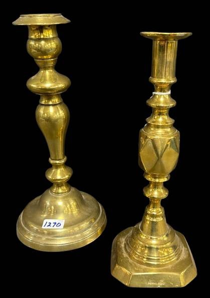 (2) English Brass Candlesticks: This pair of English brass candlesticks showcases unique designs and construction. One features an octagonal base marked'Diamond Princess' with an English registration number 385856, indicating its re
