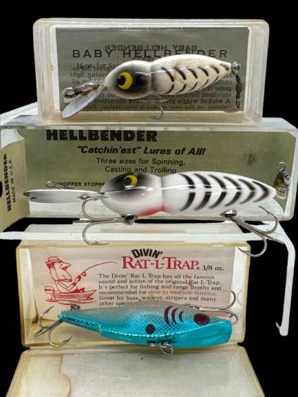 Fishing Lures in Original Boxes: This lot features three collectible fishing lures: a Baby Hellbender, Hellbender, and Divin Rat-L-Trap, all housed in their original boxes. Each lure showcases unique designs suited for various fishin