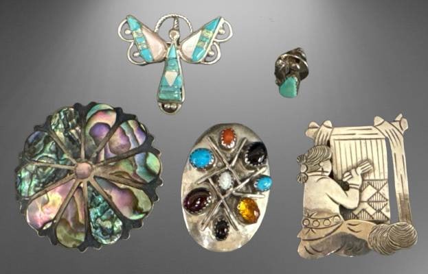 Sterling Silver and Inlay Jewelry Lot: This lot includes five unique sterling silver jewelry pieces: a Mexican abalone brooch, an oval gemstone pin, a Navajo-style weaver brooch, a butterfly inlay pendant, and a turquoise-accented cufflink